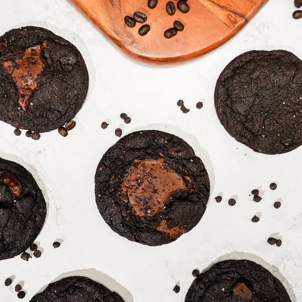 Dark chocolate cookies with molten Nutella centres finished with flaky sea salt, scattered with chocolate chips.