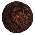 A Dark Chocolate cookie seen from above, the Nutella showing through its dark crust.